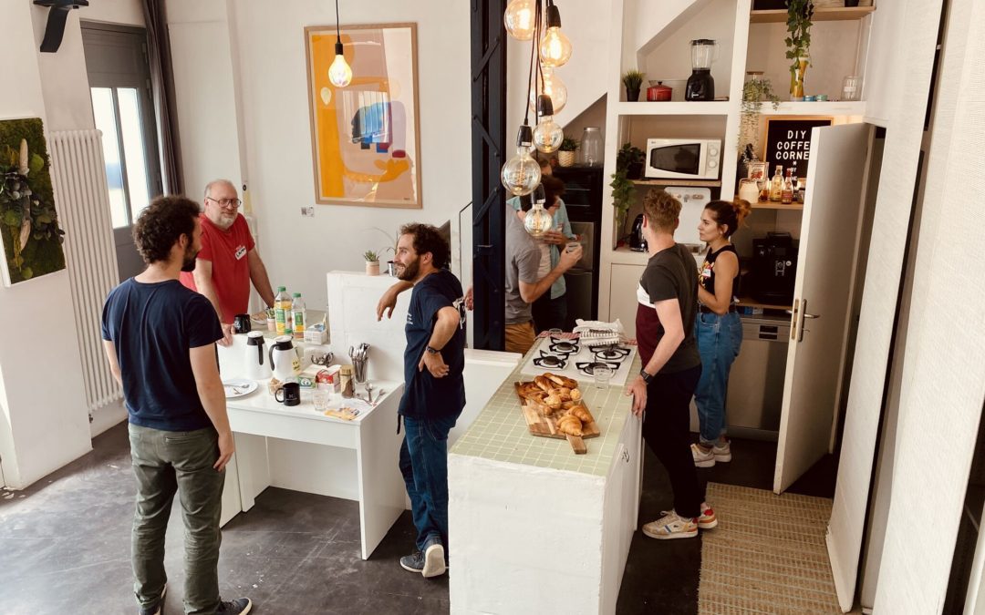 people cowork at a tablecorner