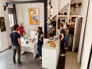 people cowork at a tablecorner